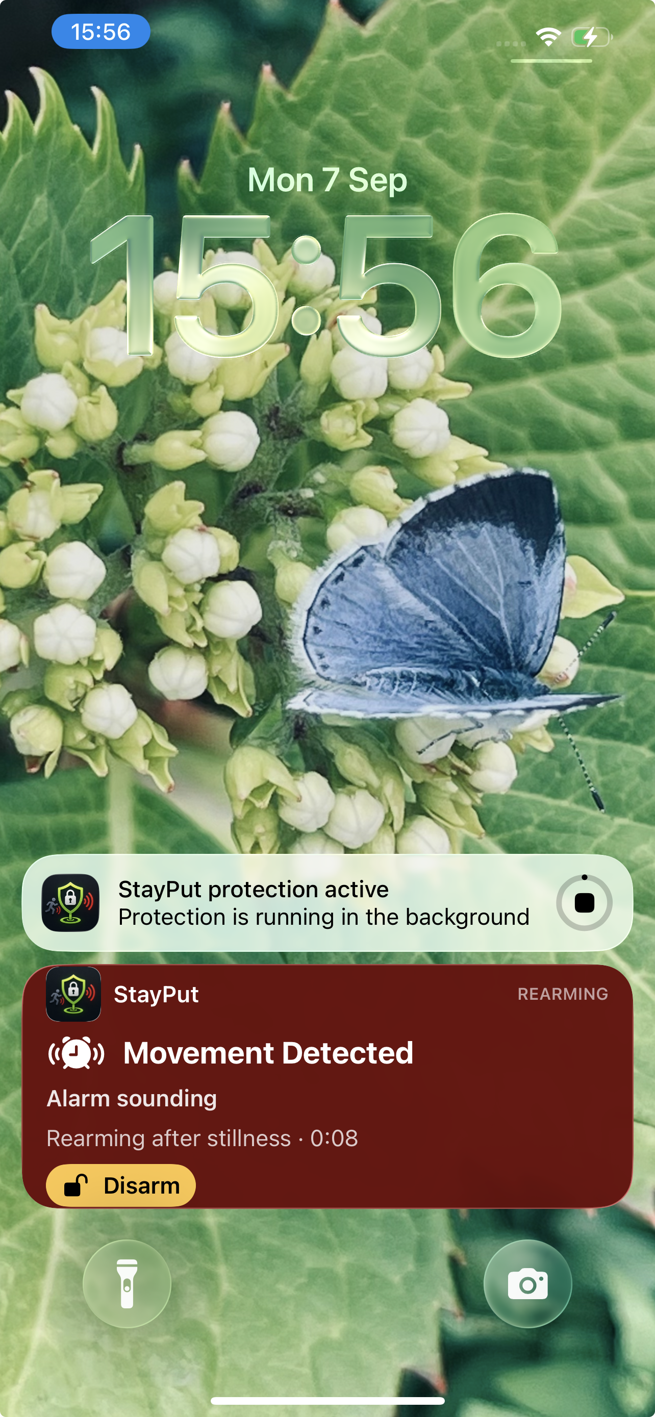 StayPut Live Activity showing movement detected and rearming on the Lock Screen.